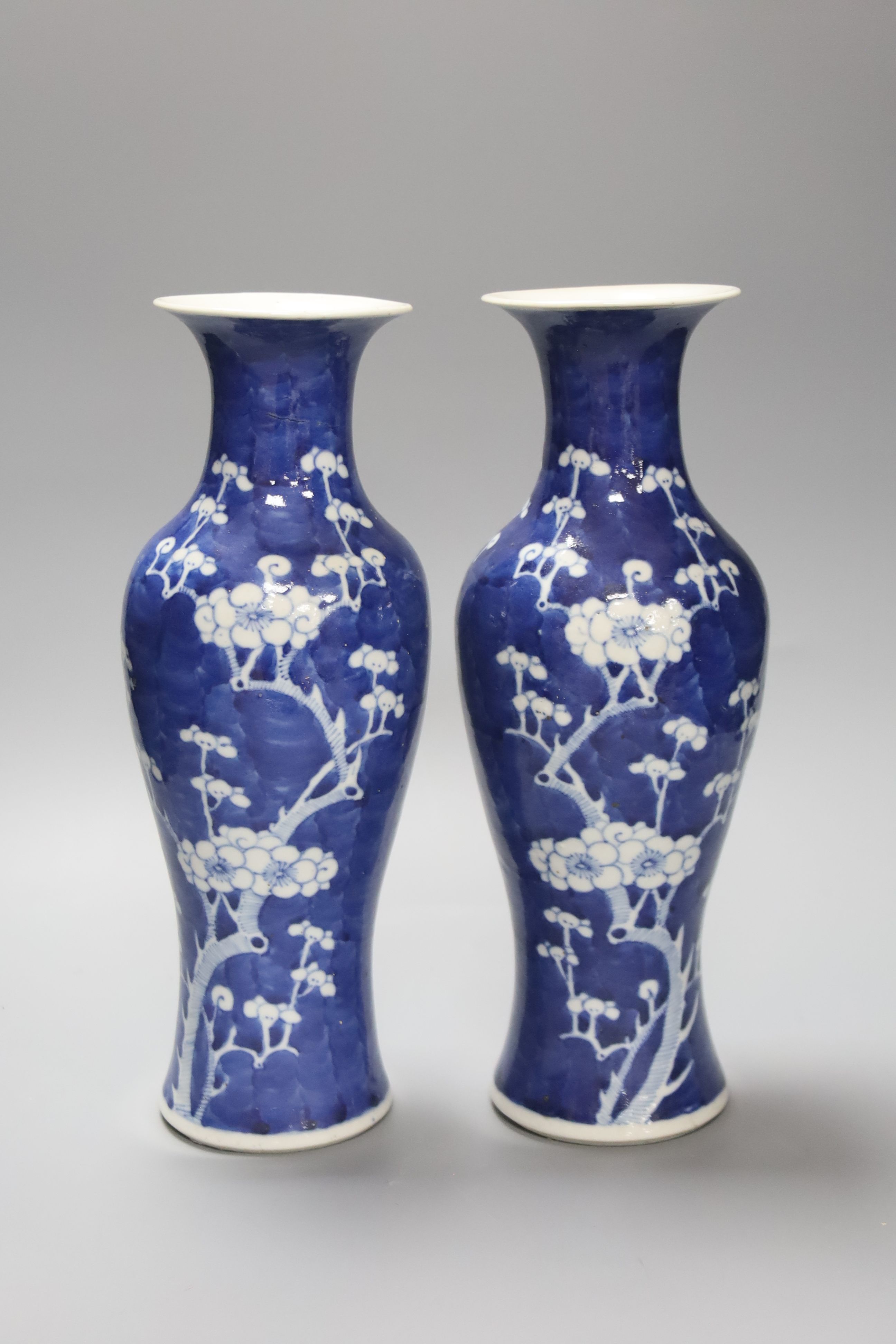A pair of slender Chinese blue and white prunus vases, late 19th century, height 30cm